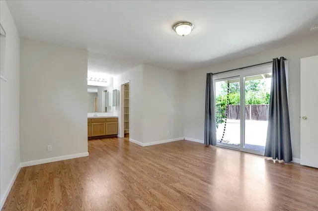 a view of a livingroom with wooden floor and a window
