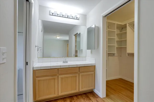 a bathroom with a granite countertop sink and a mirror