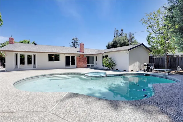 a view of a house with swimming pool and sitting area