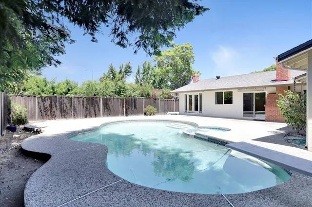 a view of a house with backyard and sitting area