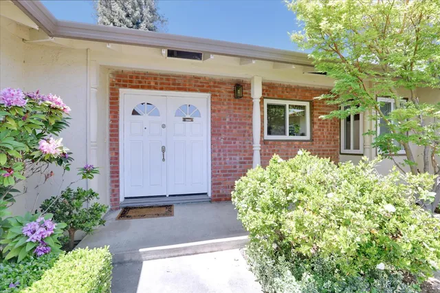a front view of a house with garden
