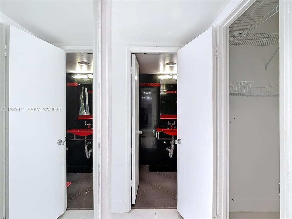 2801 Northeast 183rd Street, Unit 1504W Aventura, FL 33160 - Photo 32 of 57 a view of a bedroom from a hallway
