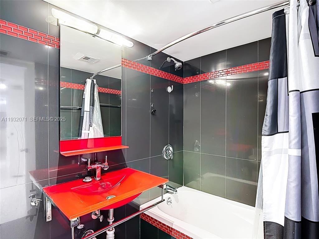 2801 Northeast 183rd Street, Unit 1504W Aventura, FL 33160 - Photo 36 of 57 a bathroom with a bath tub and shower