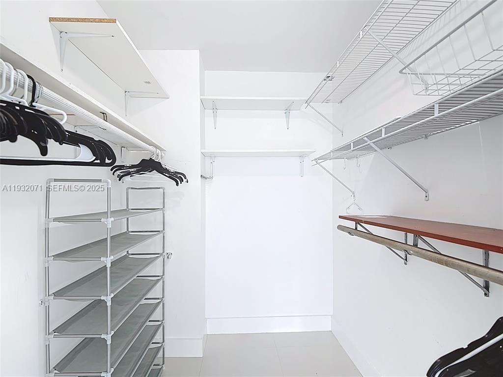 2801 Northeast 183rd Street, Unit 1504W Aventura, FL 33160 - Photo 41 of 57 a view of walk in closet with empty racks