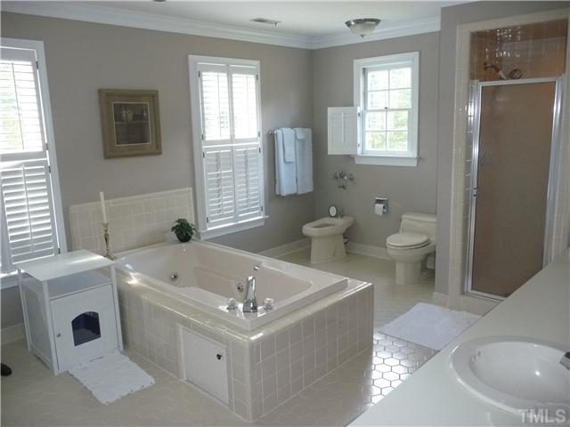 9916 Baileywick Road Raleigh, NC 27613 - Photo 16 of 25 a bathroom with a sink a toilet and tub
