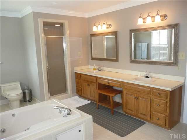 9916 Baileywick Road Raleigh, NC 27613 - Photo 17 of 25 a spacious bathroom with a tub sink and mirror
