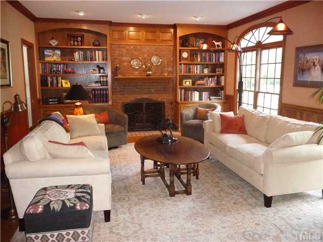 9916 Baileywick Road Raleigh, NC 27613 - Photo 7 of 25 a living room with furniture a fireplace and a large window