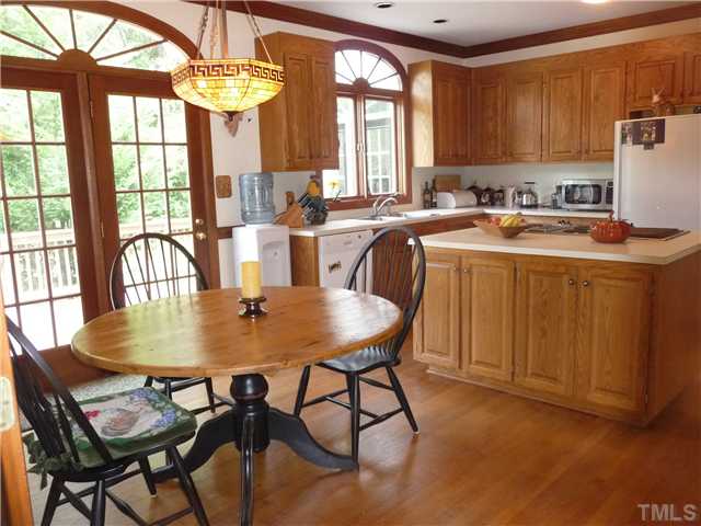 9916 Baileywick Road Raleigh, NC 27613 - Photo 10 of 25 a kitchen with a dining table chairs and chandelier