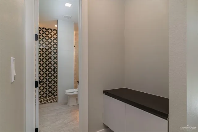 a bathroom with a sink a toilet and a shower