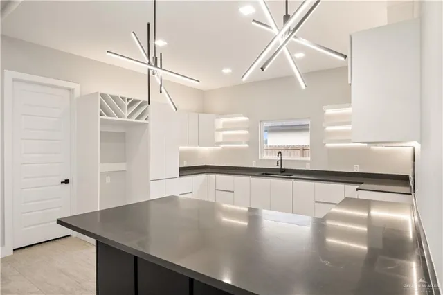 a kitchen with a counter space a sink and appliances