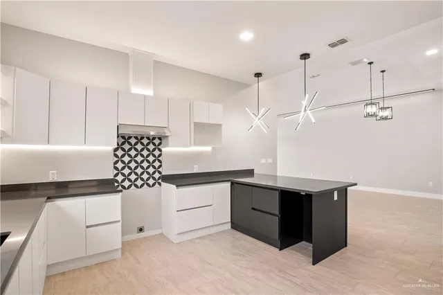 a kitchen with cabinets and window