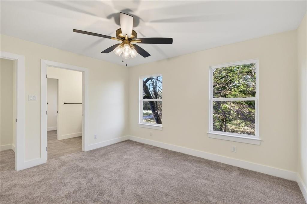114 Castlewood Road Enchanted Oaks, TX 75156 - Photo 23 of 33 an empty room with windows and fan