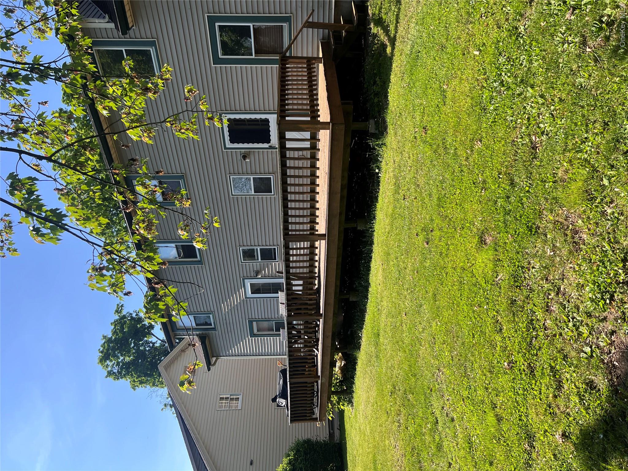 7 Berry Street Wallkill, NY 12589 - Photo 2 of 17 Expansive wooden deck with a built-in railing, offering outdoor living space