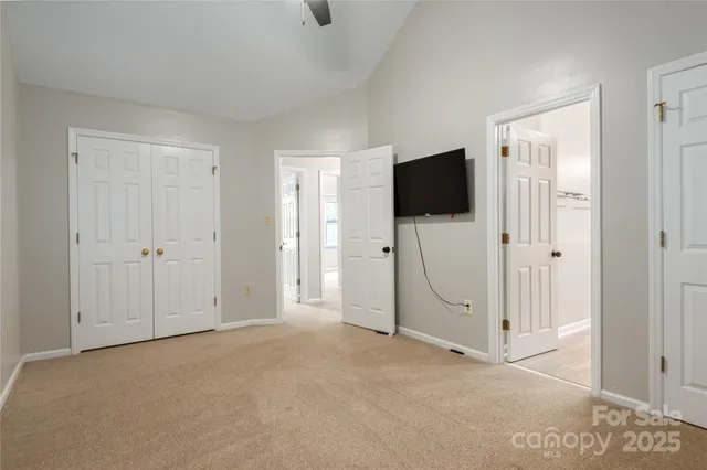 a view of a livingroom with an empty space and a bathroom