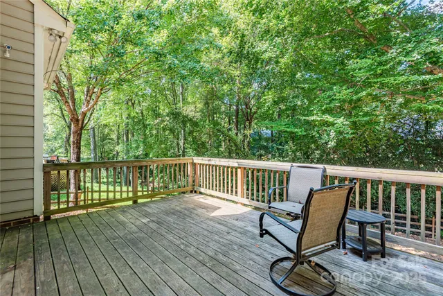 a view of balcony with wooden floor and outdoor seating