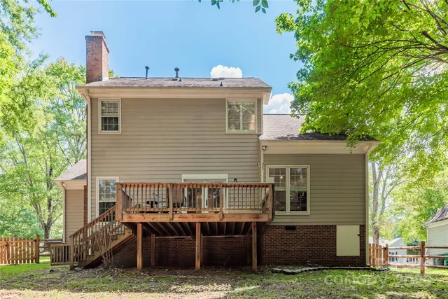 a view of a house with a yard and furniture