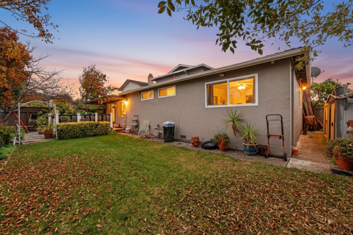 4625 Ruth Way Union City, CA 94587 - Photo 22 of 60 back of house with stucco siding, a patio area, a gate, and a chimney * Digitally altered Photograph
