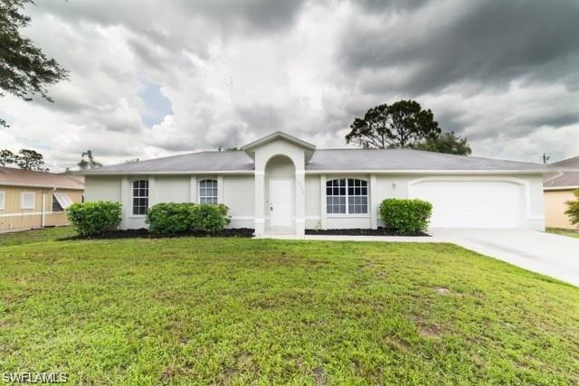 18513 Olive Road Fort Myers, FL 33967 - Photo 1 of 15 a view of a white house next to a yard with potted plants