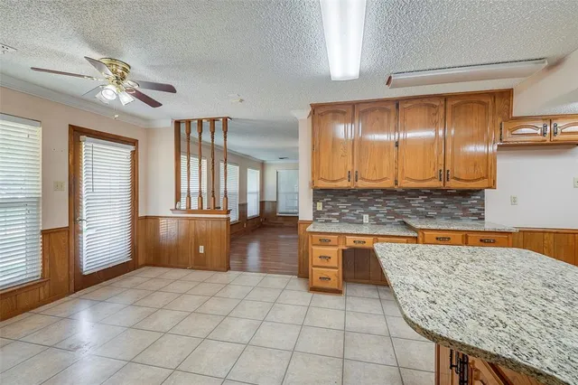 a kitchen with stainless steel appliances granite countertop a sink and cabinets