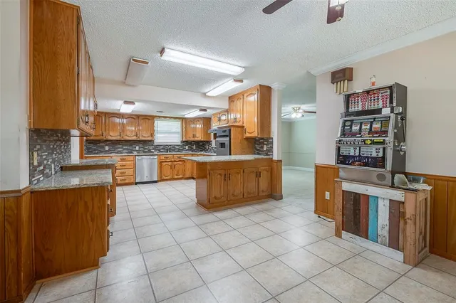 a large kitchen with stainless steel appliances lots of counter space and cabinets