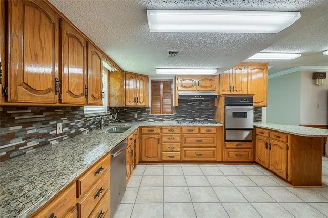 a kitchen with stainless steel appliances granite countertop a sink and cabinets