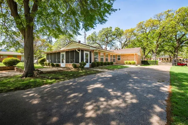 a view of an house with backyard space and balcony