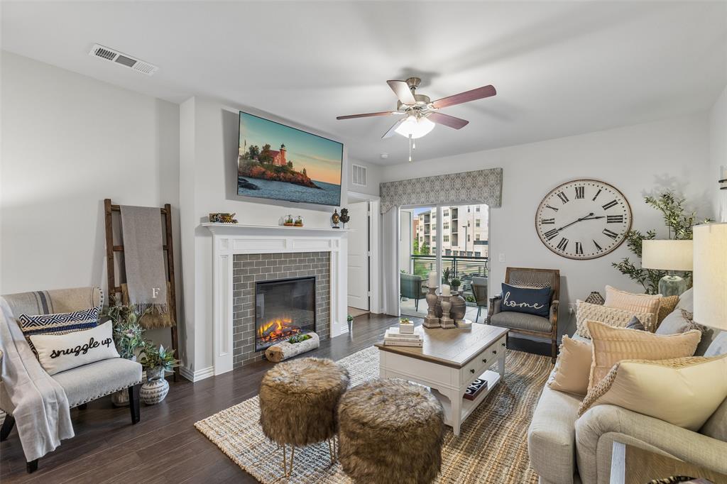 651 Watters Road, Unit 7204 Allen, TX 75013 - Photo 4 of 40 a living room with furniture a fireplace and a flat screen tv