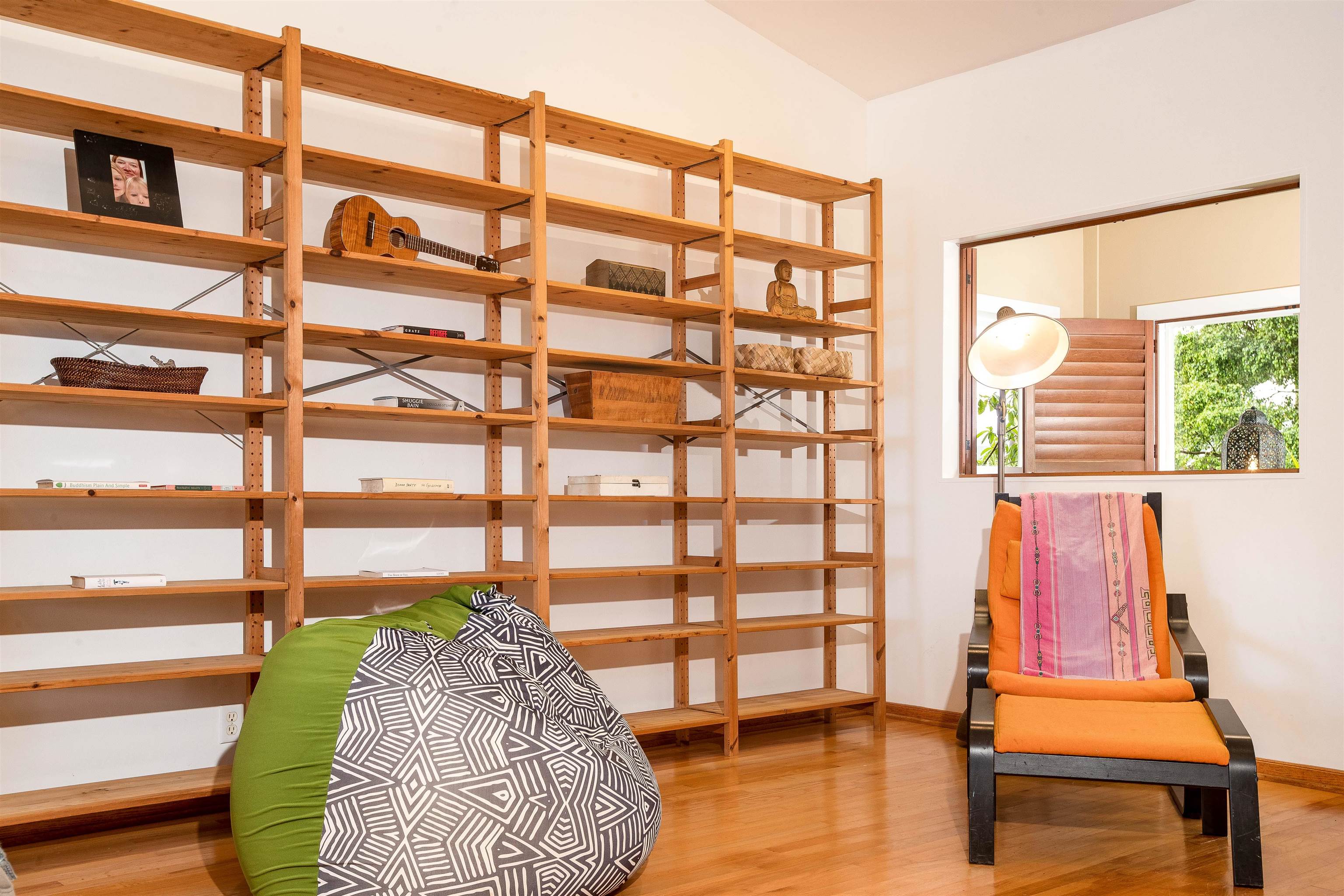 9 Kapii Place Haiku, HI 96708 - Photo 10 of 30 a bedroom with a bed and a bookshelf next to a window