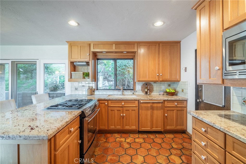 22 Deerhill Drive Rolling Hills Estates, CA 90274 - Photo 16 of 39 a kitchen with granite countertop sink stove and cabinets