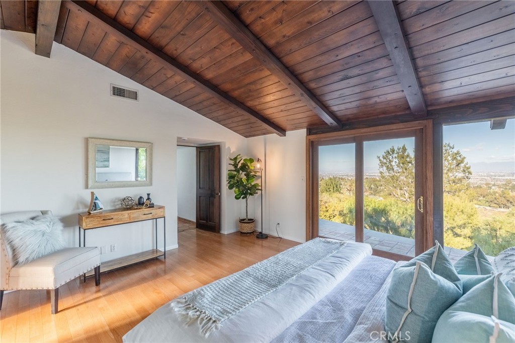 22 Deerhill Drive Rolling Hills Estates, CA 90274 - Photo 20 of 39 a spacious bedroom with a bed and glass windows