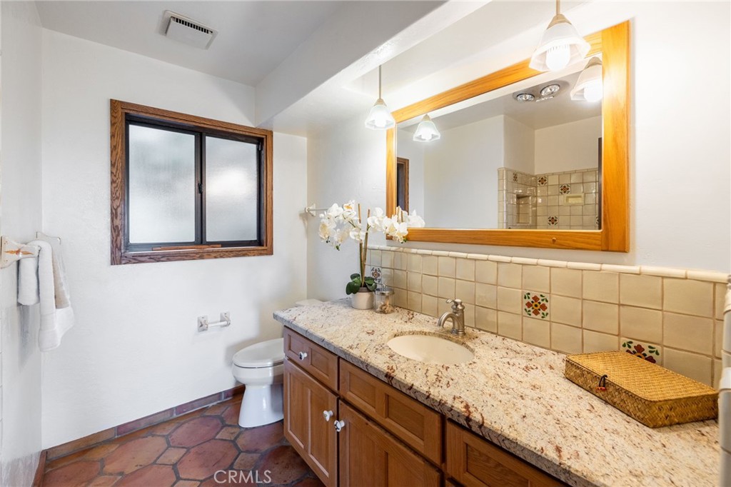 22 Deerhill Drive Rolling Hills Estates, CA 90274 - Photo 21 of 39 a bathroom with a granite countertop sink and a mirror