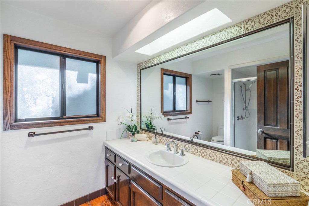 22 Deerhill Drive Rolling Hills Estates, CA 90274 - Photo 22 of 39 a bathroom with a sink and a mirror