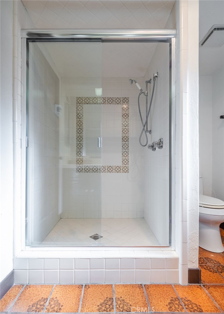 22 Deerhill Drive Rolling Hills Estates, CA 90274 - Photo 23 of 39 a bathroom with a glass shower door and a window