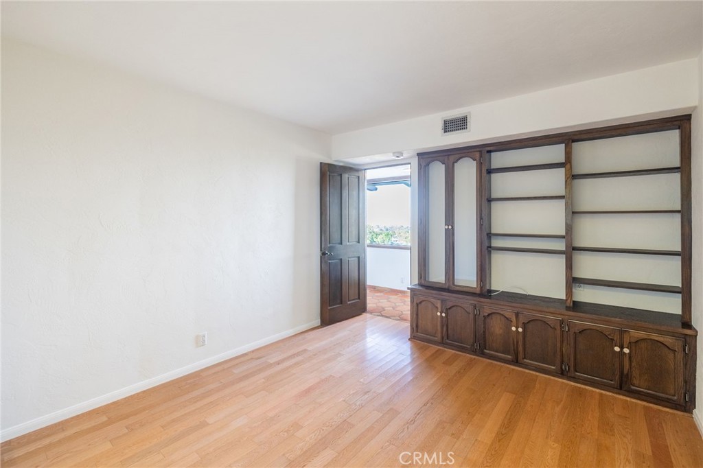 22 Deerhill Drive Rolling Hills Estates, CA 90274 - Photo 28 of 39 a view of an empty room with wooden floor and a window