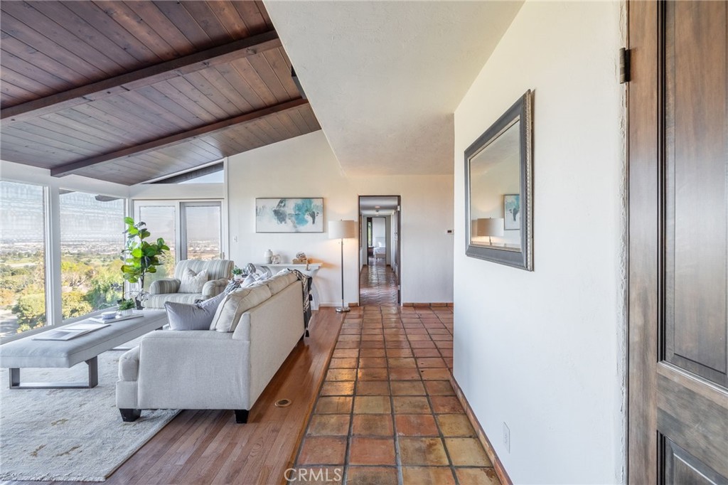 22 Deerhill Drive Rolling Hills Estates, CA 90274 - Photo 10 of 39 a hallway with wooden floor and furniture