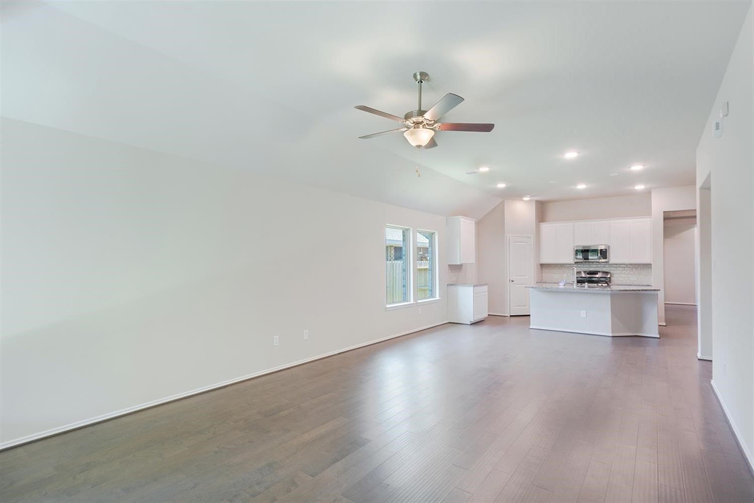 553 Timber Voyage Court Conroe, TX 77304 - Photo 13 of 31 a view of an empty room with a kitchen