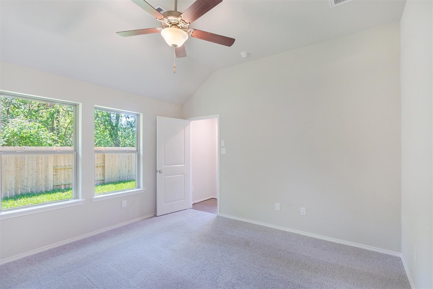 553 Timber Voyage Court Conroe, TX 77304 - Photo 14 of 31 a view of an empty room with a window