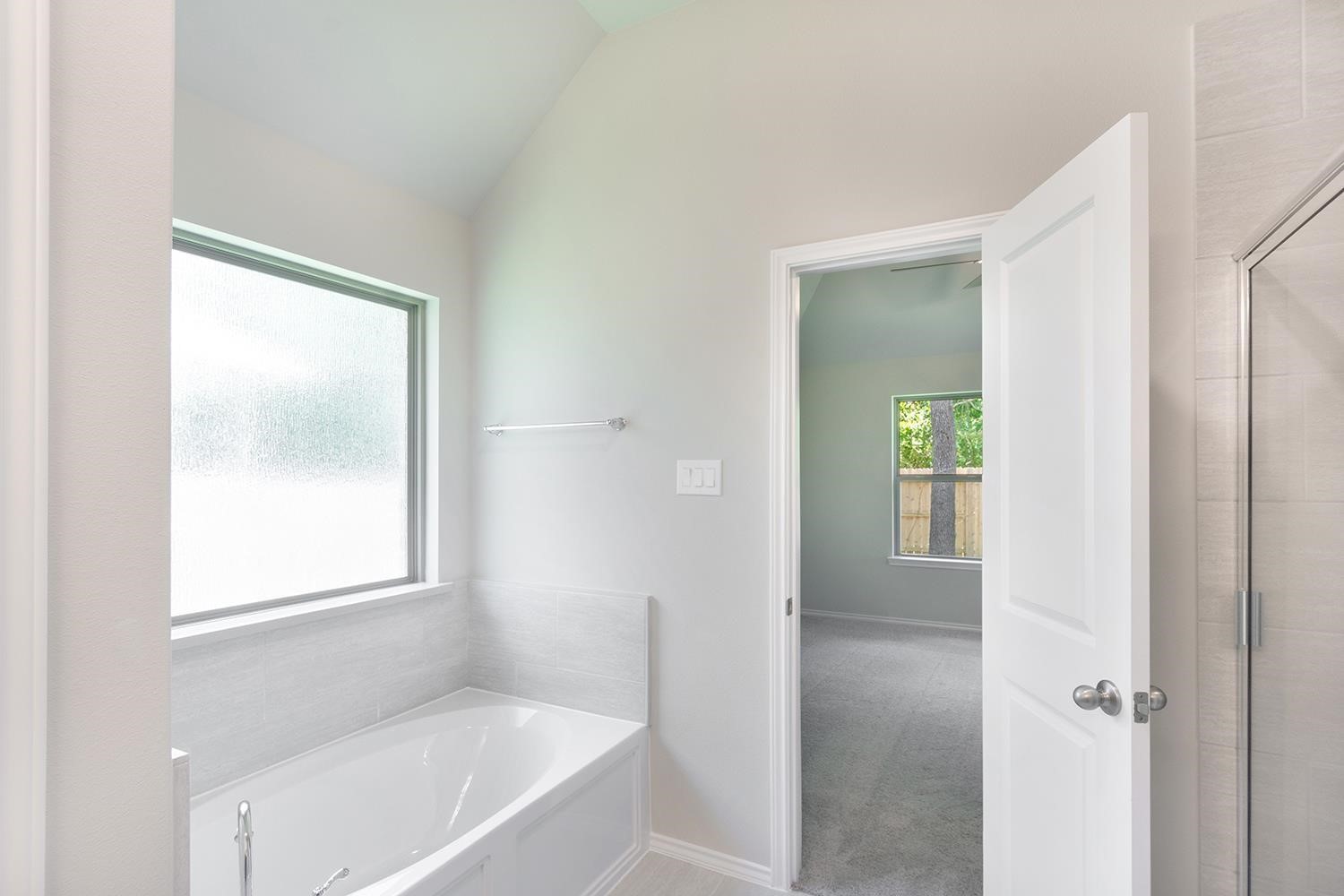 553 Timber Voyage Court Conroe, TX 77304 - Photo 17 of 31 a bathroom with a bathtub and a shower