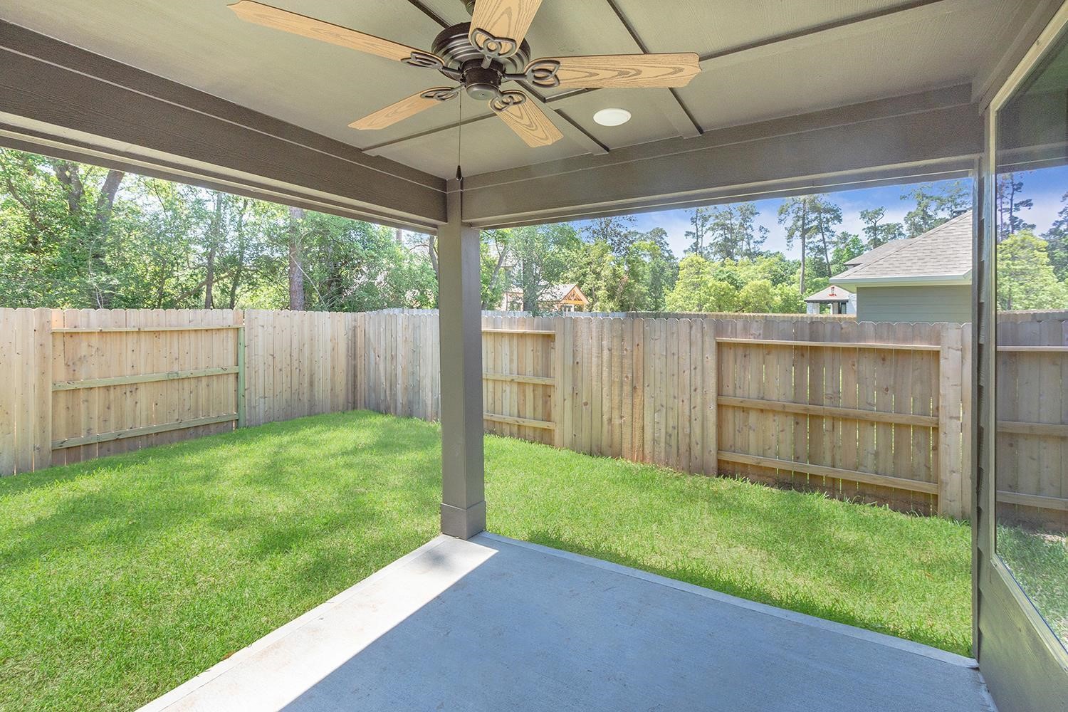 553 Timber Voyage Court Conroe, TX 77304 - Photo 22 of 31 a view of a backyard with a garden