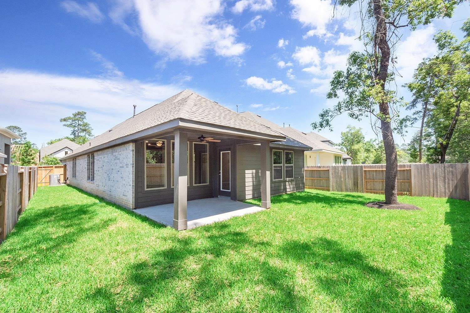 553 Timber Voyage Court Conroe, TX 77304 - Photo 24 of 31 a view of a house with a yard and porch