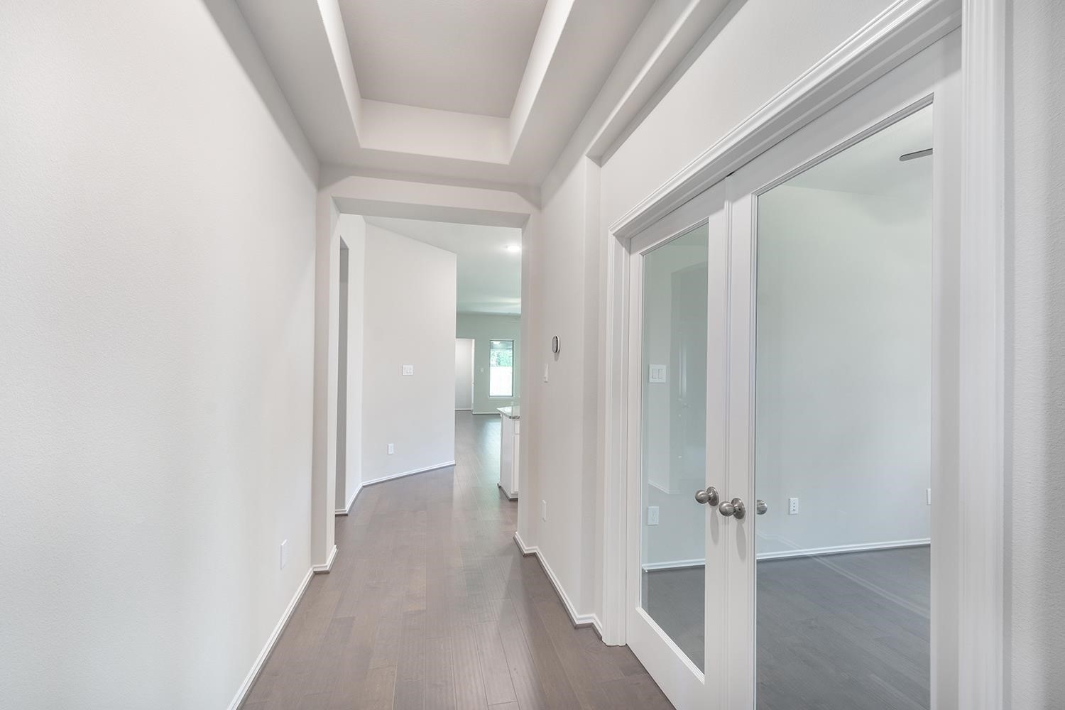 553 Timber Voyage Court Conroe, TX 77304 - Photo 3 of 31 a view of a hallway with wooden shelves
