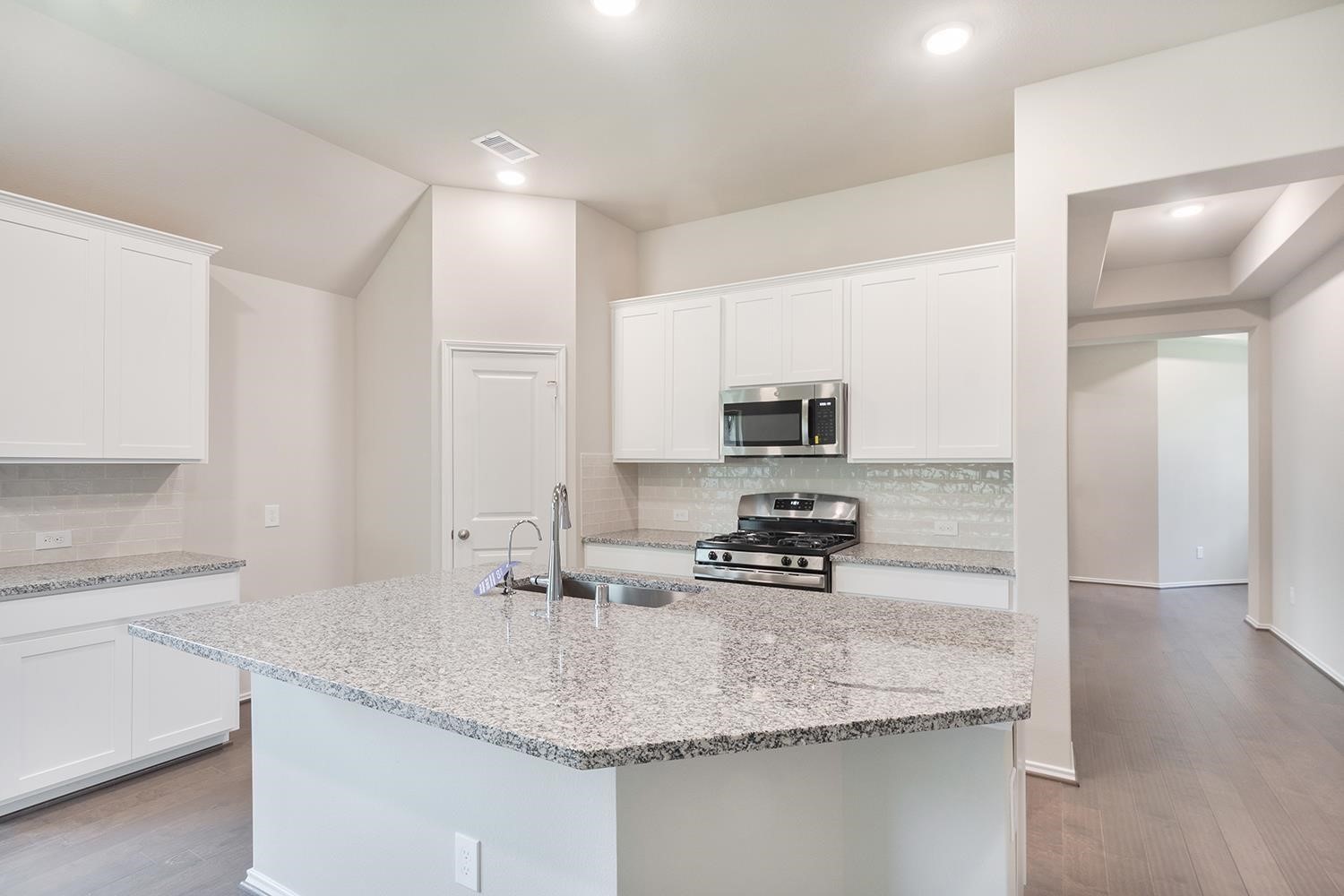 553 Timber Voyage Court Conroe, TX 77304 - Photo 8 of 31 a kitchen with stainless steel appliances granite countertop a sink stove and refrigerator