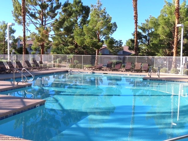 1623 Cave Spring Drive Henderson, NV 89014 - Photo 13 of 16 A sparkling pool with abundant deck chairs awaits in this tranquil, fenced outdoor oasis.