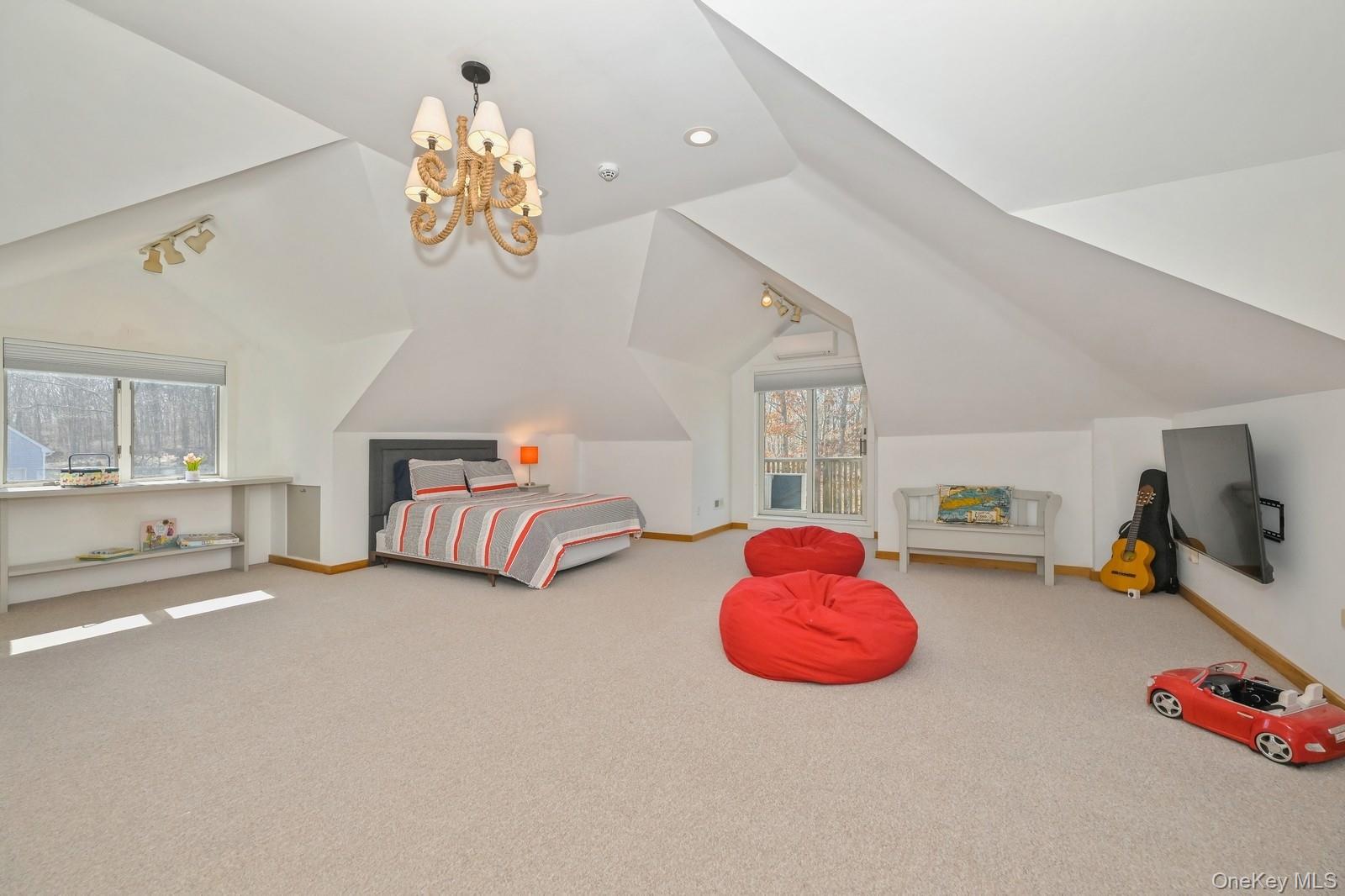 16 Hildreth Road Hampton Bays, NY 11946 - Photo 16 of 29 a bedroom with furniture and a chandelier