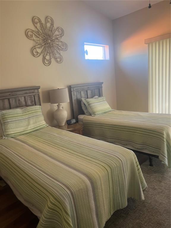 5373 Compass Point, Unit 1 Oxford, FL 34484 - Photo 16 of 38 a bedroom with a bed and a chandelier