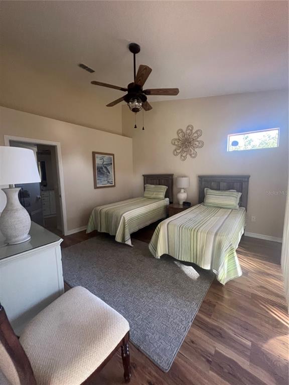 5373 Compass Point, Unit 1 Oxford, FL 34484 - Photo 17 of 38 a bedroom with a bed and a chandelier