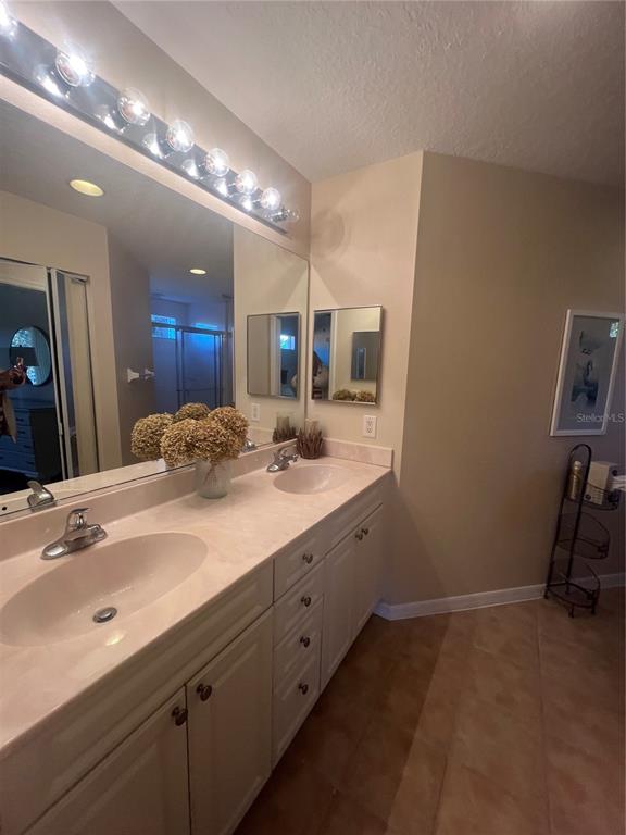 5373 Compass Point, Unit 1 Oxford, FL 34484 - Photo 18 of 38 a bathroom with a sink double vanity and a mirror