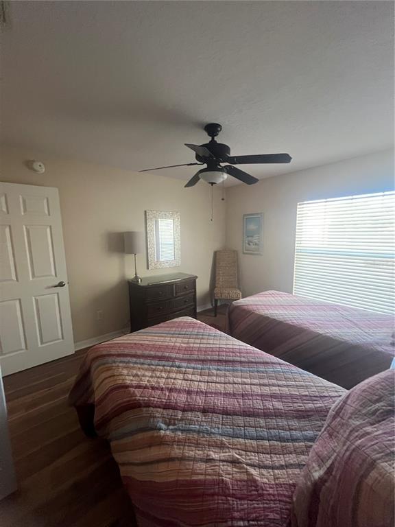 5373 Compass Point, Unit 1 Oxford, FL 34484 - Photo 22 of 38 a bedroom with a bed and a chandelier