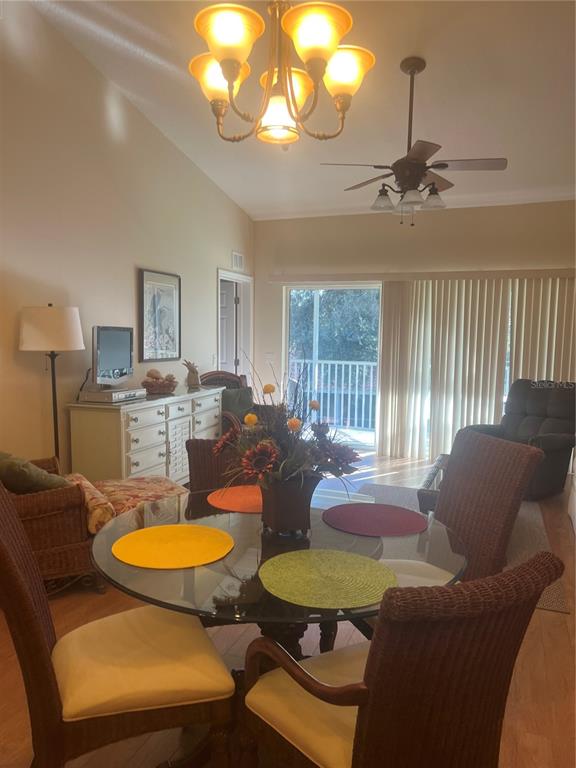 5373 Compass Point, Unit 1 Oxford, FL 34484 - Photo 5 of 38 a living room with furniture a chandelier and a dining table
