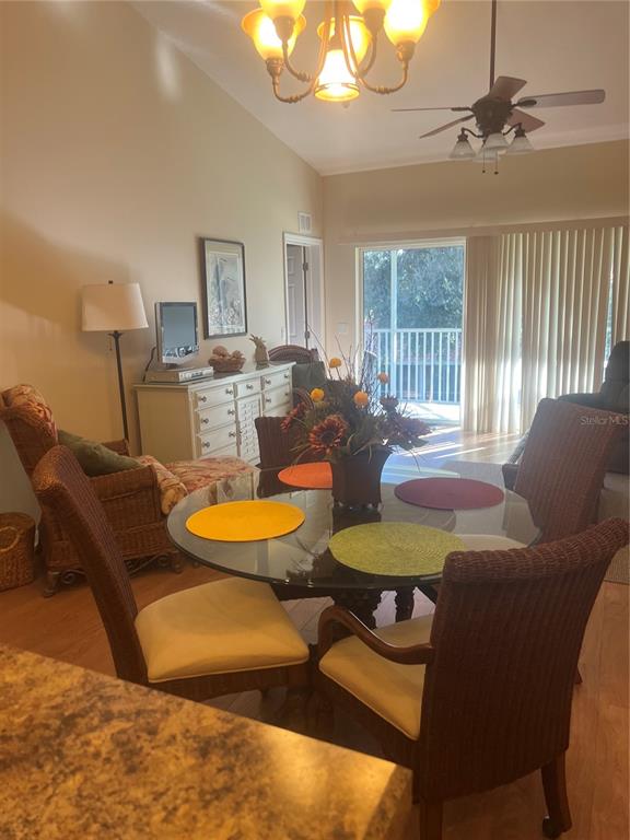 5373 Compass Point, Unit 1 Oxford, FL 34484 - Photo 6 of 38 a view of a dining room with furniture a chandelier and large windows